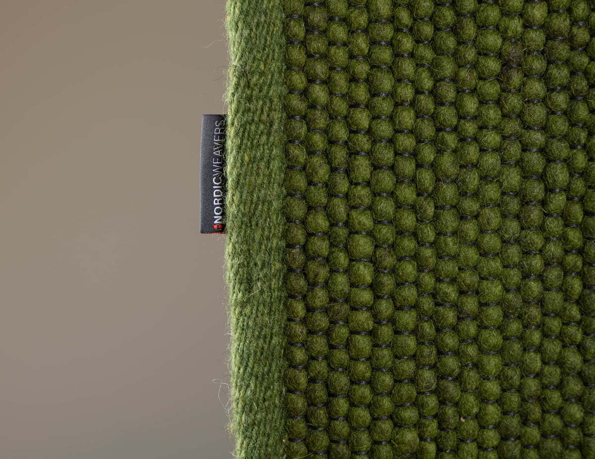 Dywan wełniany - Lett zielony - close up zijkant Dywan wełniany - Lett zielony - close up zijkant